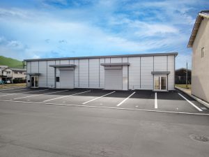 事務所兼倉庫の外観3。正面右側から。建物右側に倉庫側の出入り口が備わっている。