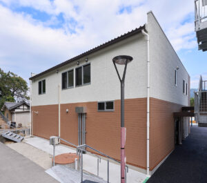 2階建て倉庫兼事務所の外観裏手。右斜めから見た建物の裏手と外階段。